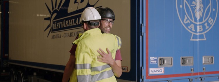 Fredric and Lars Kristen hug in front of the lorry six months after the accident.